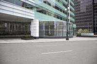 a street view of some tall buildings and windows and some lamps and a sidewalk with no people