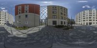 360 view of a street with several buildings in the background from a fish eye lens