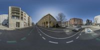 this is a fish eye view of the streets in europe where you can see the cars and building