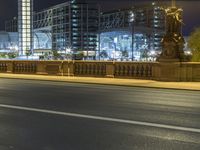 a very tall building sits behind the city street that runs along the street on a bridge