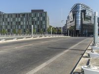 a city street with a very modern architecture on the left side and some white toilets in the middle of the street