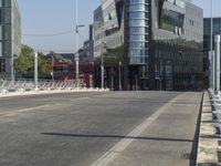 a city street with a very modern architecture on the left side and some white toilets in the middle of the street