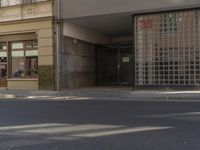 a parking meter is on a pole in the street next to buildings of a store