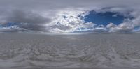 the time lapse image shows a sand and cloudscape with a view in this very small panorama