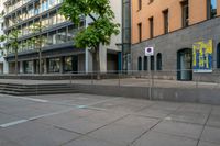 a very empty sidewalk and some very nice buildings with the stairs out front of it