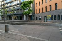 a very empty sidewalk and some very nice buildings with the stairs out front of it