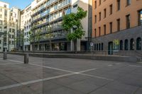 a building with large windows is located in a city square with no traffic on it