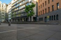 a building with large windows is located in a city square with no traffic on it