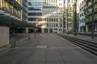 some buildings that are by a bunch of steps on a sidewalk in front of some stairs