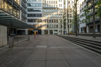 some buildings that are by a bunch of steps on a sidewalk in front of some stairs