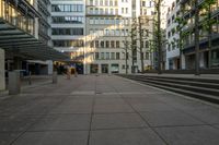 some buildings that are by a bunch of steps on a sidewalk in front of some stairs