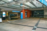 a bus station with an indoor sign and a television set outside it's front door