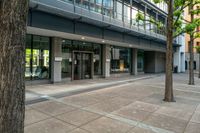 there is a picture of an empty parking lot in front of the building and a sidewalk