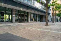 there is a picture of an empty parking lot in front of the building and a sidewalk