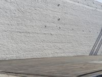 a fire hydrant is sitting on an industrial area that has a lot of white brick