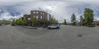 the photo shows the circular view of a city street, with parked cars in front