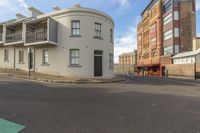 a street view of a commercial building and a bus station in the distance, from which no one can cross