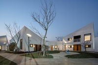 the view of a courtyard that is empty and there are many trees outside of it