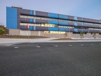 the exterior of an elementary in front of a modern building with light reflecting off of the windows