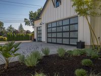 garage door with metal frame in front and bushes in the background with blue sky overhead