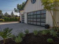 garage door with metal frame in front and bushes in the background with blue sky overhead