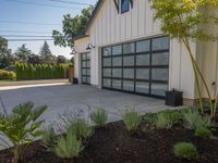 garage door with metal frame in front and bushes in the background with blue sky overhead