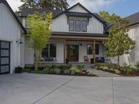 the garage is built with a roof overhang and a front porch with a walkway that goes to a garage door