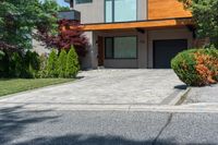 a modern style home with wood and glass windows on one of the sides of its driveway