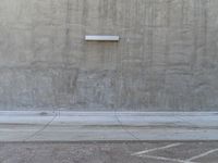 a man is standing with his arms spread in front of the wall and pointing at it