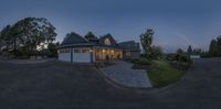 a picture taken from the front of a house at dusk in the evening with an outside patio