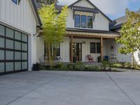 a house on a residential lot with an attached garage door that leads to a front porch