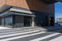 a building with a bike parked on the side of it under a blue sky,