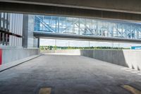 an overpass above a building with a glass bridge that goes over it to the left