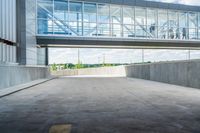 an overpass above a building with a glass bridge that goes over it to the left