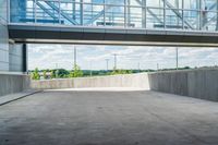 an overpass above a building with a glass bridge that goes over it to the left