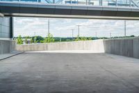 an overpass above a building with a glass bridge that goes over it to the left