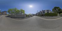 360 - view image of street in urban area in front of buildings and fenced in park