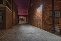 an alleyway leading to a building at night with no people or people in it