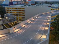 a view of a road and an overpass with traffic passing through it by buildings