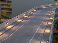 a view of a road and an overpass with traffic passing through it by buildings