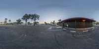 a street is shown through a 360 - zoom lens shot of a parking area in a suburban neighborhood