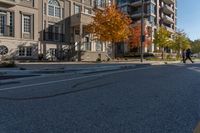 the young boy is riding a skateboard in the sidewalk area of the residential community