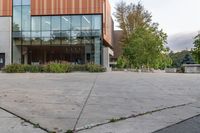 an empty courtyard of a school building with the entrance open to the campus in front of the building