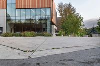 an empty courtyard of a school building with the entrance open to the campus in front of the building