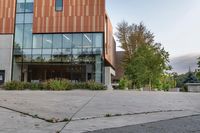 an empty courtyard of a school building with the entrance open to the campus in front of the building