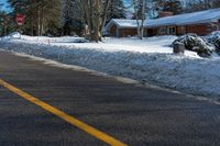 a street sign is in front of a snowed area with a road below it