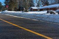 a street sign is in front of a snowed area with a road below it