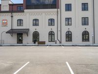 a building that looks like an old red and white fire hydrant in front of a parking lot