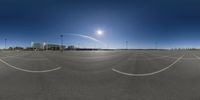 this is an empty parking lot for a plane to fly over it in a sunny sky