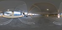 a 360 - view of a long parking garage and a tunnel at the top of a ramp